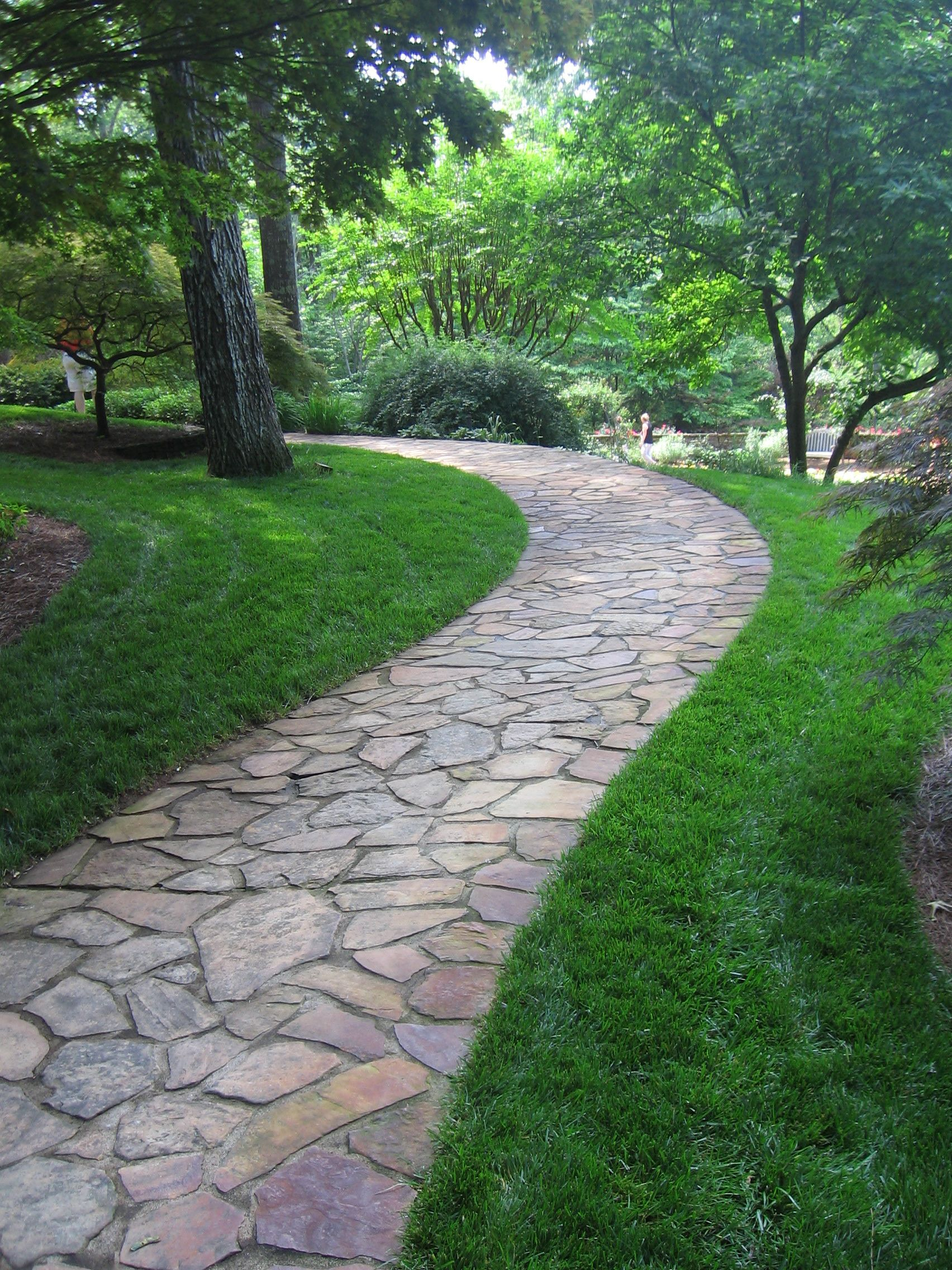 Flagstone Pathway At Gibbs Gardens intended for Turning an Empty Yard Into a Cohesive Landscape With Strategic Path Placement